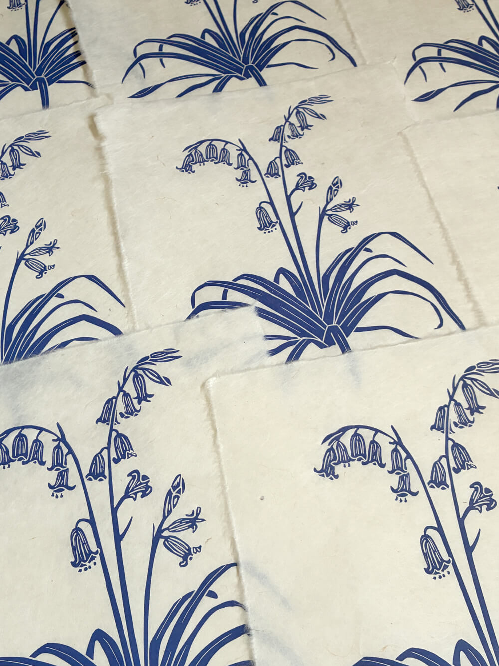Print edition of handcrafted and printed bluebell linocut art.