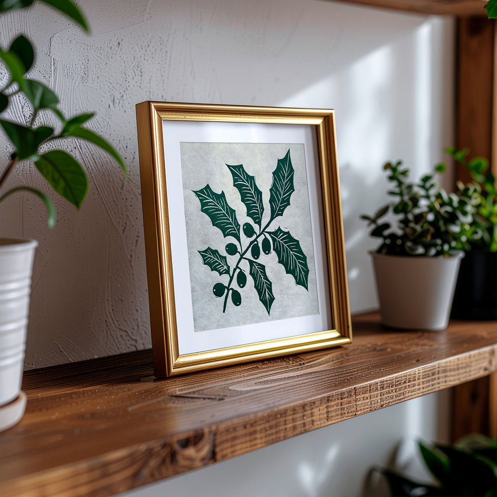 Handmade linocut print in a brass frame on a shelf carved and hand printed by UK artist Sam Luck.