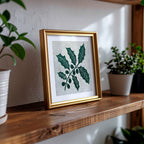 Handmade linocut print in a brass frame on a shelf carved and hand printed by UK artist Sam Luck.