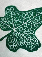 Close up detail of an ivy leaf botanical linocut print in green.