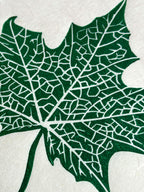 Close up detail of a maple leaf botanical linocut print in green