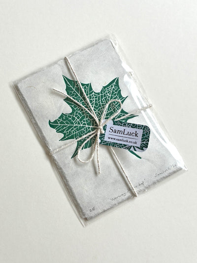 Handmade maple leaf linocut print, gift wrapped with string and a blank gift tag. Ready to give as a thoughtful present for nature lovers.