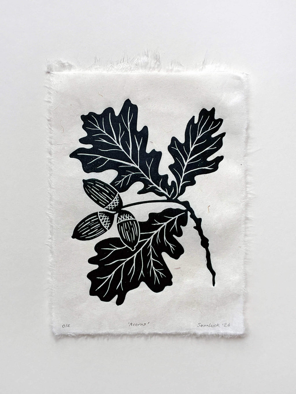 Handmade linocut botanical wall art print featuring oak leaves and acorns in green on an isolated background.