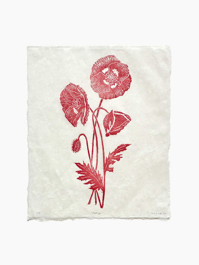Handmade wild poppies linocut print on handmade paper, view from above, isolated on white background hand printed by UK linocut artist Sam Luck