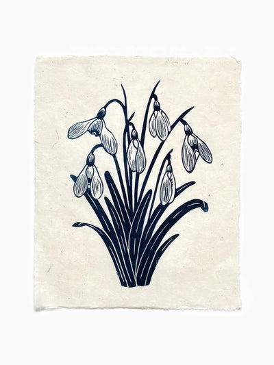 Handmade snowdrops linocut print on handmade paper in blue, full view from above on white background, hand printed by UK linocut artist Sam Luck