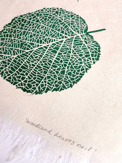 Close up of the texture of a green linocut leaf print signed by Sam Luck in her UK studio.